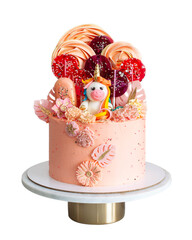 Cute pink birthday cake for a little girl with fondant unicorn, meringue swirls. lollipops,...