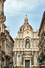 historic tenement houses and Baroque facade of the Cathedral Basilica of St. Agates in the city of Catania, on the island of Sicily