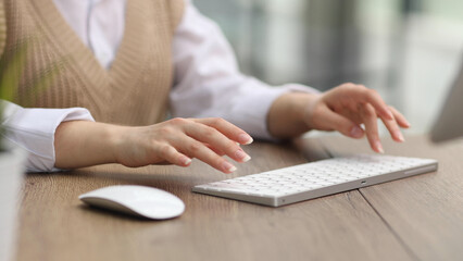 female hands are typing on a computer keyboard.