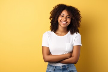 Young beautiful girl in a white T-shirt on a yellow background