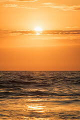 Fototapeta premium Ocean waves on sunset background