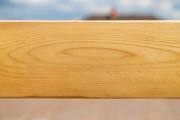 Newly cut and dressed wooden plank with large knot at the center. Photo with copy space