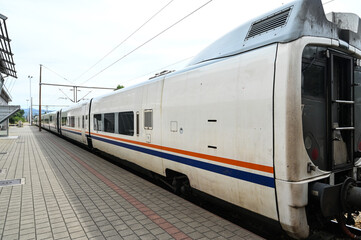 Naklejka premium Passenger train on railway station. Wagons. Transportation. 