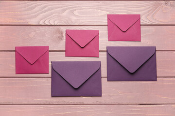 Different envelopes on wooden background
