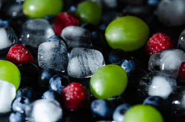 berries with ice cubes on a black background