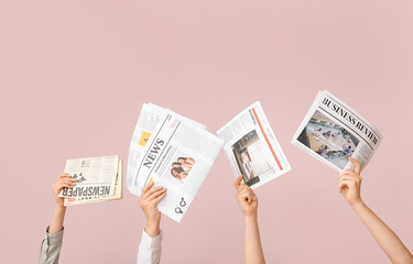 Female hands with different newspapers on color background