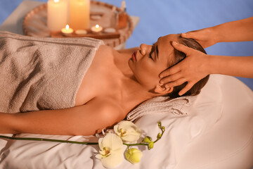Obraz na płótnie Canvas Pretty young woman having face massage in spa salon