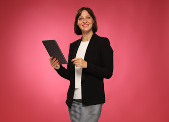 portrait of businesswoman with smartphone and tablet isolated on pink background