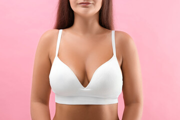Fototapeta premium Woman with beautiful breast on pink background, closeup