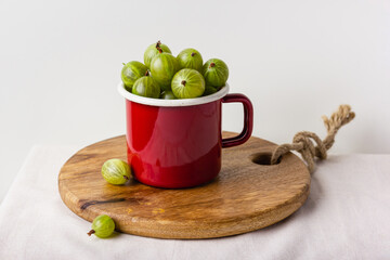 Gooseberry in a red enamel mug