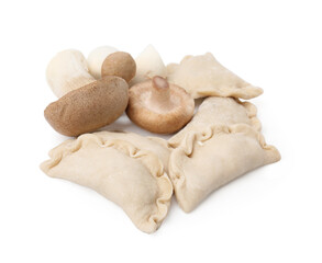 Raw dumplings (varenyky) and fresh mushrooms isolated on white