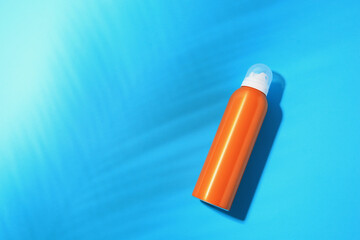 Sunscreen on light blue background, top view and space for text. Sun protection care
