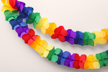 Rainbow paper garlands on beige background. LGBT pride