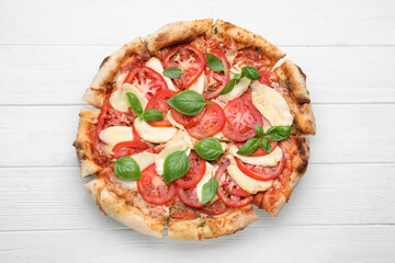 Delicious Caprese pizza on white wooden table, top view