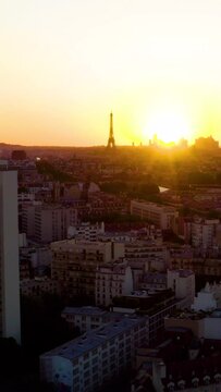 Aerial view of Paris France skyline rooftops sunset. Aerial drone panoramic view of Paris Eiffel Tower. Panoramic view of Paris at sunset. Aerial vertical,&nbsp;vertical video background.