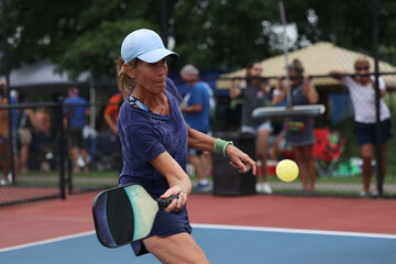 senior woman pickleball shot