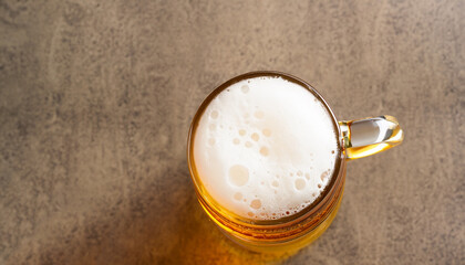 Top view of beer glass with foam cap and copyspace