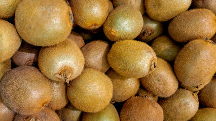 A load of fresh kiwis filling the frame, food or produce background asset.