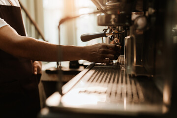 Selective focus, Hand Barista making coffee with espresso coffee machine in coffee shop. Closeup, Coffee making concept.