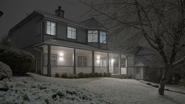 Establishing shot of luxury house with nice landscape at winter snowfall at night in Vancouver, Canada, North America. Night time on December 2022. ProRes 422 HQ.
