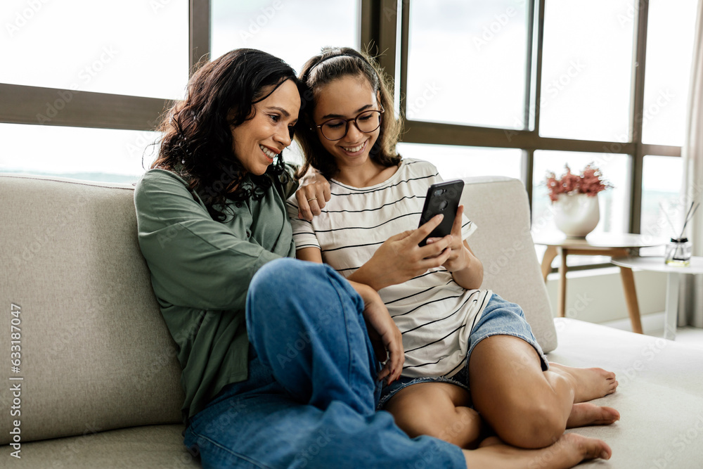 Wall mural Single parenthood. Mother and daughter spending time together at home.