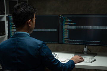 Obraz na płótnie Canvas IT programmer working on desktop computer Male expert innovating software engineer app development program check coding in bugging system.