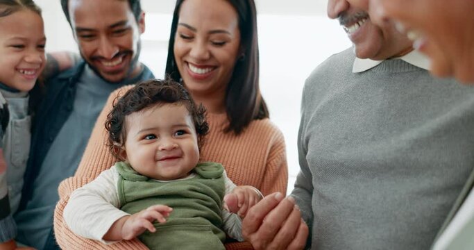 Happy, love and big family playing with a infant baby bonding with care and happiness at home. Happiness, smile and newborn child with his parents, sibling and grandparents at the family house.