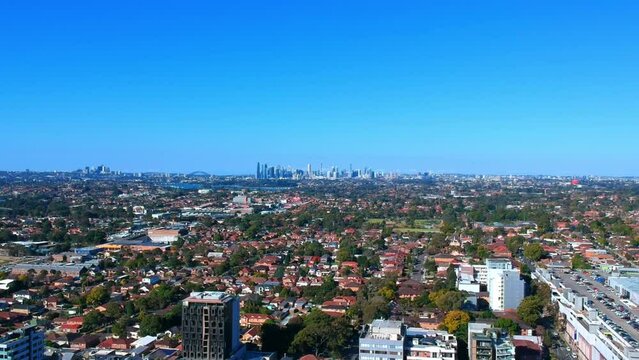 Drone view looking down on Commercial Suburb of Burwood in Sydney residential houses in suburbia suburban house roof tops and streets park NSW Australia 