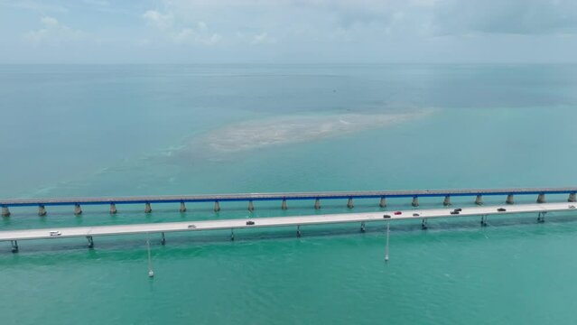 Aerial tracking shot following cars along the Seven Mile Bridge in the Florida Keys