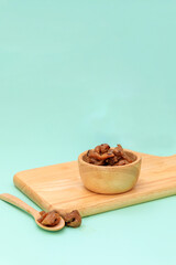 Dried and fresh longan fruit on  board