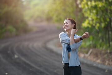 young fitness woman runner athlete running at road. warm up before exercise on countryside street. sport tight clothes. bright sunset,  Healthy woman on morning road workout jogging.