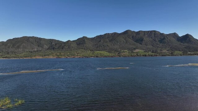Drone video of mountains by a like in Colombia