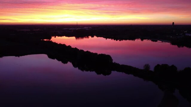 A drone lowers over the sunset reflection in the waters of Mechels Broek.