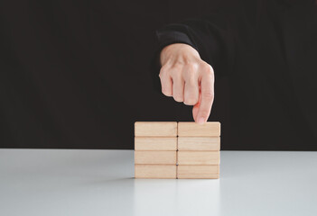 Businessperson choose of wooden blocks. concept Development and planning in business with strategy for success.	
