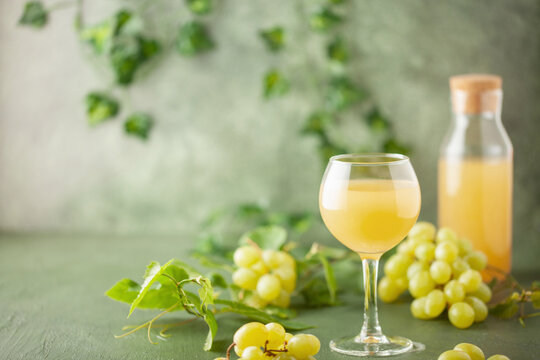 Traditional Czech low alcohol new white wine Burcak, or Neuer Wein,  Vin bourru in wineglasses with grapes bunches