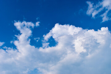 beautiful blue sky and white fluffy group of clouds with sunrise in the morning, natural background