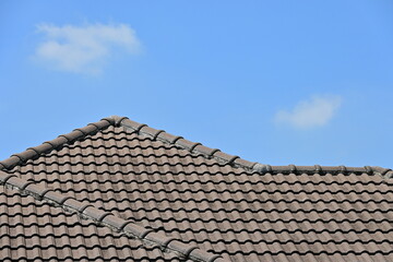 Fototapeta premium grey roof tile of house on blue sky and white cloud background