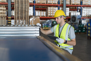 Metalwork manufacturing, warehouse of raw materials. Male warehouse worker inspecting quality...