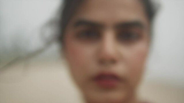 Cinematic close up of the face of an Indian fashion model wearing a nose ring in Goa, India, Slow Motion