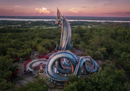 Phaya Si Mukda Maha Muni Nilapala Nakkharat The King of giant Naga statue at Wat Phu Manorom in sunset,Mukdahan Province Thailand.