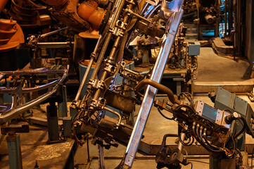 Robotic welder machine tools process metal details in shop