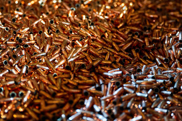 Sparkling golden bullets heap for firearms as background