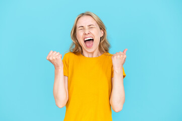 Portrait of emotional screaming woman enjoying success or win