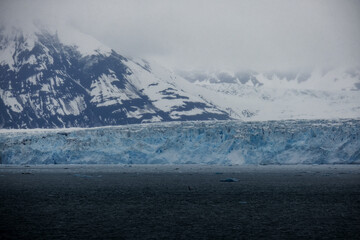 Cruise to Hubbard Glacier Bay in Alaska with floating ice bergs and drift ice floes on ocean water surface surrounded by snow cap mountains and wildlife wild nature scenery Last Frontier adventure
