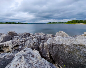 beautiful lake in conservation park surrounded by stones. belwood lake conservation park, Ontario, Cananda 