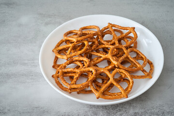 salt pretzel in white bowl on table background. pretzel food background. pretzel snack food                                                        