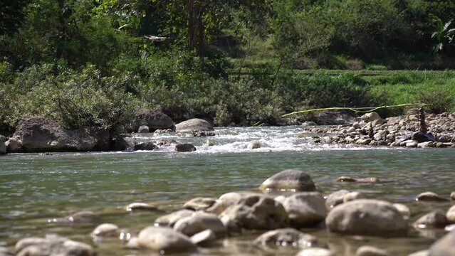 clear river flow between the rocks, very fresh and clean.