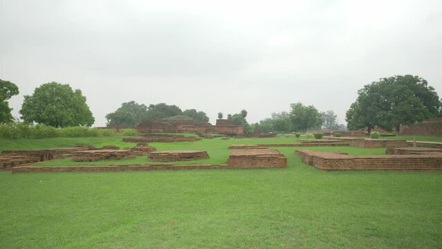 Wide shot of the ruins on the site of Nalanda Mahavihara an ancient Unesco World Heritage site famous as the oldest Buddhist monastic university that was demolished by Mughal Invaders, overcast cloudy
