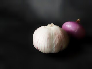 garlic and onion on black background
