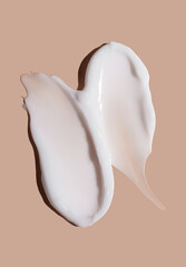 Cosmetic smear of cream texture on a beige background. Skin care.